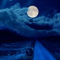 railroad in night under full moon in clouds Royalty Free Stock Photo