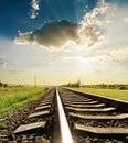 Railroad with reflections under sunset Royalty Free Stock Photo