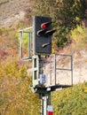 A railroad signal as a railroad traffic light stands on red