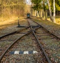 Railroad switch on old mining tracks with cart in back in open air museum by Stribro