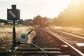 Railroad switch with train in the morning sun Royalty Free Stock Photo