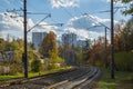 Railroad track in the city park with tall high rise houses on the background Royalty Free Stock Photo