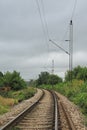 Railroad track perspective with electricity post
