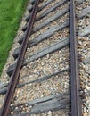 Railroad track with the roadbed in rocks and rusty rails