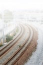 Foggy Railroad tracks city suburb Royalty Free Stock Photo