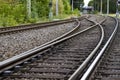 railroad tracks in a countryside surroundes by trees, electrical overhead line, with a switch Royalty Free Stock Photo