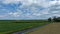 Railroad Tracks Curve Gently Through A Lush Agricultural Landscape With Fields Of Various Shades Royalty Free Stock Photo