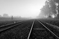 Railroad tracks in the fog. Foggy morning over a railway line in Central Europe Royalty Free Stock Photo