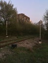 Railroad tracks in the forest. Tall buildings. Abstraction and emptiness. Royalty Free Stock Photo