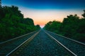 Railroad tracks heading east into the sunrise