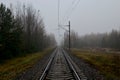 Railroad tracks in a misty haze after rain in the autumn