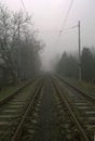 Railroad tracks partially covered in white fog Royalty Free Stock Photo