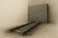 The railroad tracks rest against a brick wall, a metaphor for a dead end. Space for text. Royalty Free Stock Photo