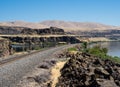 Railroad tracks running along Columbia River Gorge in WA, USA Royalty Free Stock Photo