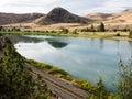 Railroad tracks running along Flathead river in Montana, USA Royalty Free Stock Photo