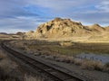 Railroad tracks running past a desert ranch