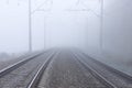 Railroad tracks stretching into the misty distance. The path into fog Royalty Free Stock Photo