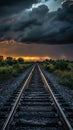 Railroad tracks at sunset under dramatic storm clouds, nature and travel concept Royalty Free Stock Photo