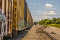 Railroad tracks and train with graffiti back view