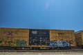 Railroad tracks and train with graffiti side view