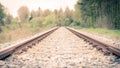 Railroad Tracks Trough The Forest With A Curve At The End Royalty Free Stock Photo