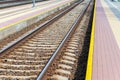 Railroad tracks urban shoot. Leading line view.iron rusty train railway over dark stones rail way Royalty Free Stock Photo