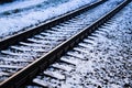 Railroad tracks in a winter foggy morning sprinkled with snow Royalty Free Stock Photo