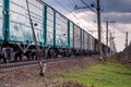 Railroad Train passing by a wooden rural house in a web of wires Royalty Free Stock Photo