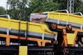 The railroad train platforms with gondola cars that contain a conveyor belt with a rubber-fabric tape for mechanized accumulation, Royalty Free Stock Photo