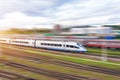 Railroad travel passenger train with motion blur effect, industrial a district of the city