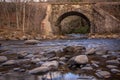 Railroad tressel over reflective and shallow Lehigh River in late autumn