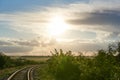 Railroad turns among the green trees in the summer Royalty Free Stock Photo