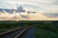 Railroad turns among the green trees in the summer Royalty Free Stock Photo