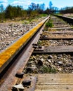 Railroad. Vintage railroad. Iron rusty train railway detail over dark stones. Royalty Free Stock Photo