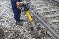 Railroad worker using vertical vibration tamper Royalty Free Stock Photo