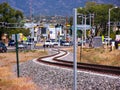 Curving railroad train tracks serpentine into one of the main traffic intersections in Santa Fe NM