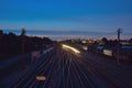 Rails and passing train at night