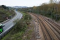 Railtracks and road arriving to Oviedo. City in the background Royalty Free Stock Photo