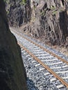 Railwai track between steep rocks Royalty Free Stock Photo