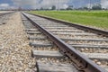 Railway approaching to exterior facade of Auschwitz Birkenau concentration camp Royalty Free Stock Photo