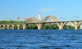 Railway arched bridge across the Dnieper River with a view of the Dnipro city Royalty Free Stock Photo