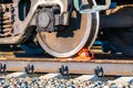 railway brake shoe under the wheel of a railway car standing on a siding awaiting loading or dispatch of cargo