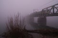 Railway Bridge Across River In Dark Foggy Winter Morning Royalty Free Stock Photo