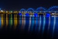 Railway Bridge crosses the Daugava river in Riga at night. Panoramic view on Riga the capital of Latvia city from left bank of Royalty Free Stock Photo