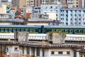 Railway bridge over old residential area with train moving Royalty Free Stock Photo