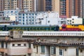 Railway bridge over old residential area with train moving Royalty Free Stock Photo