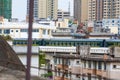 Railway bridge over old residential area with train moving Royalty Free Stock Photo