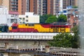 Railway bridge over old residential area with train moving Royalty Free Stock Photo