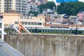 Railway bridge over old residential area with train moving Royalty Free Stock Photo