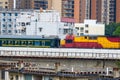 Railway bridge over old residential area with train moving Royalty Free Stock Photo